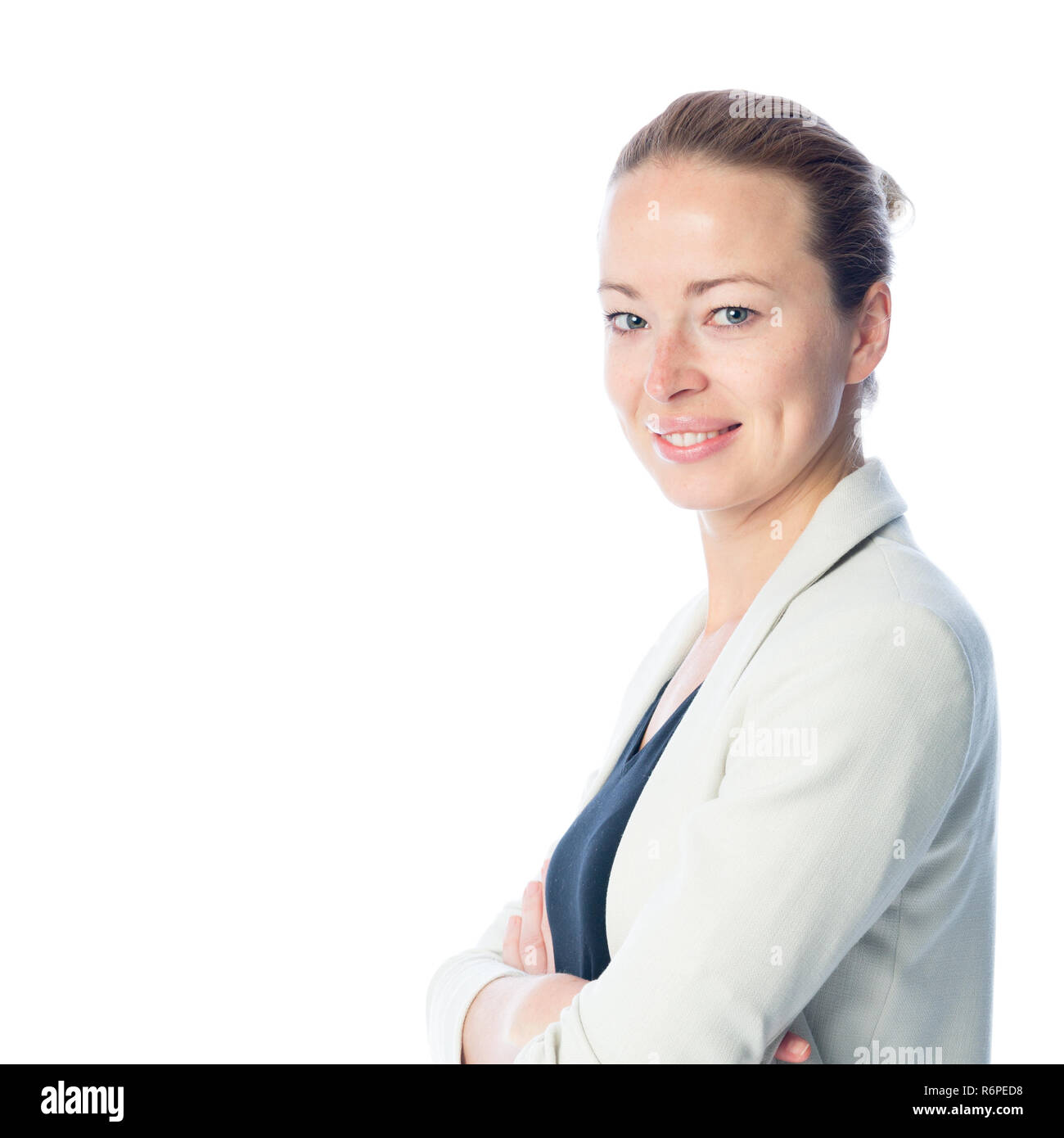 Business woman standing with arms crossed against white background. Stock Photo
