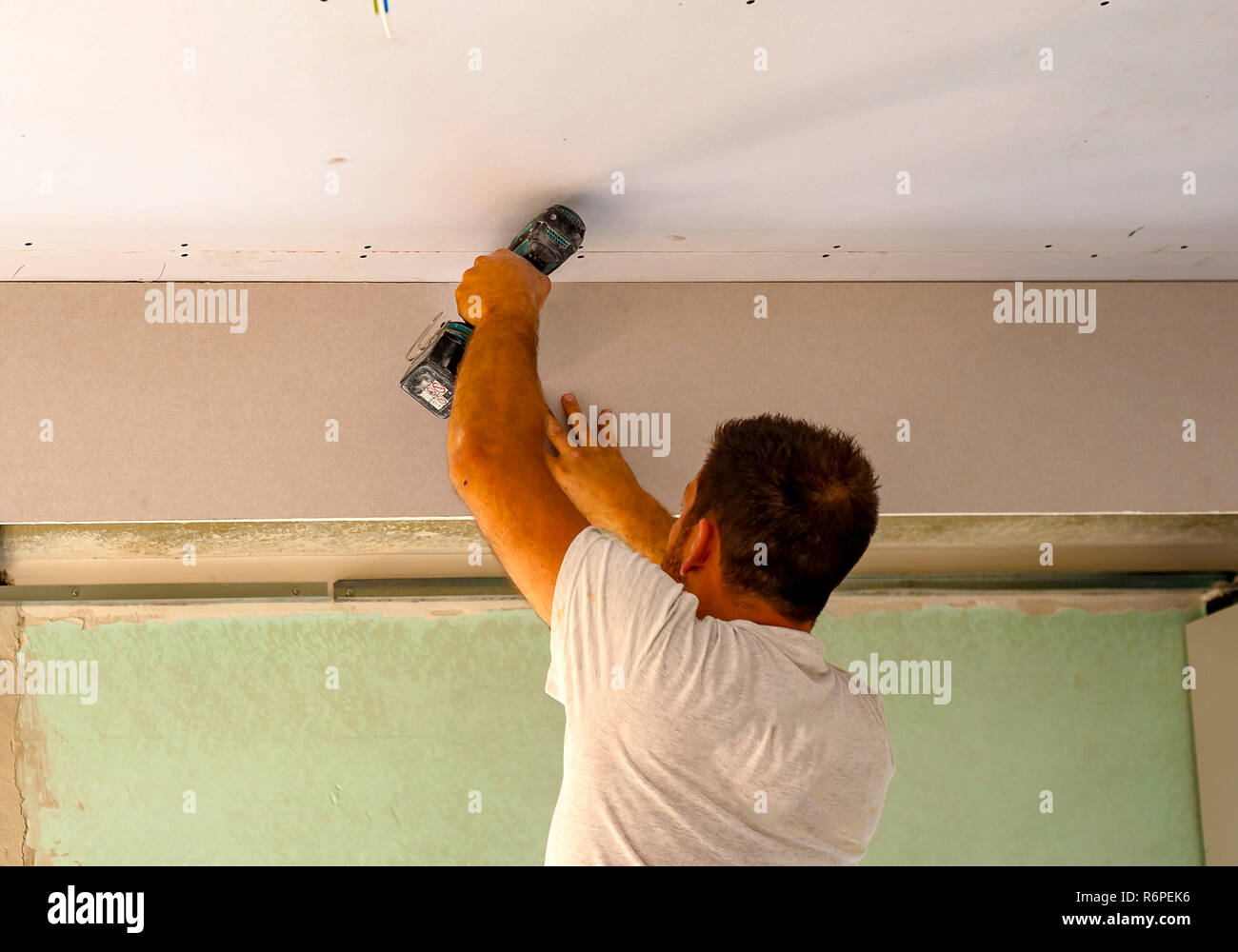 Fixing plasterboard sheets to the frame. Stock Photo