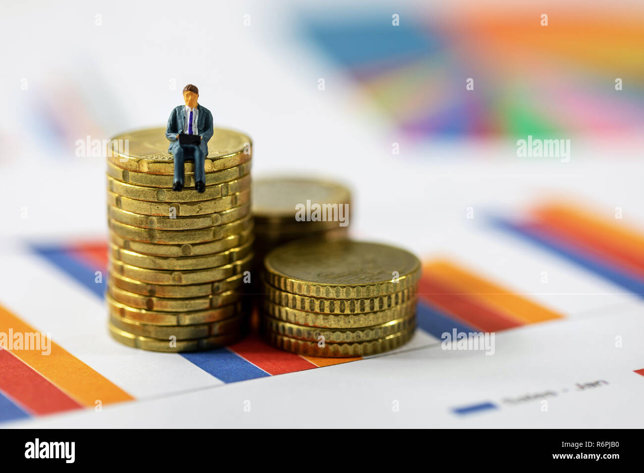 business growth concept - businessman sitting on coin stack Stock Photo