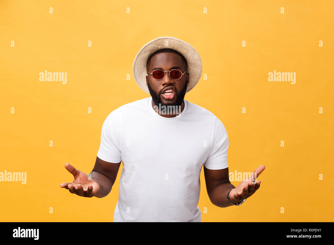 Young african american man wearing white t-shirt shouting and screaming loud to side with hand on mouth. Communication concept. Stock Photo
