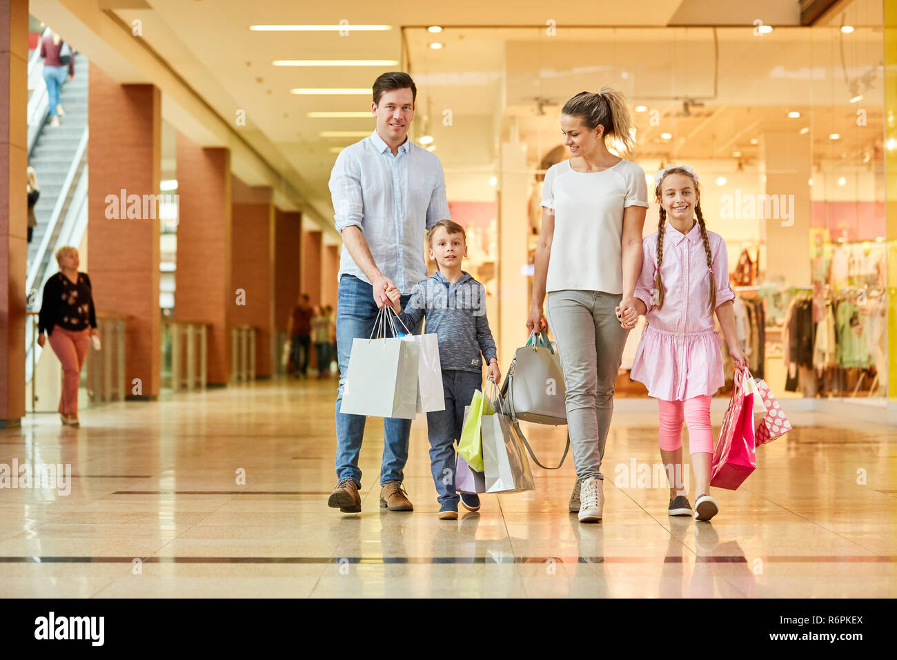 Happy family with shopping bags goes shopping while shopping Stock