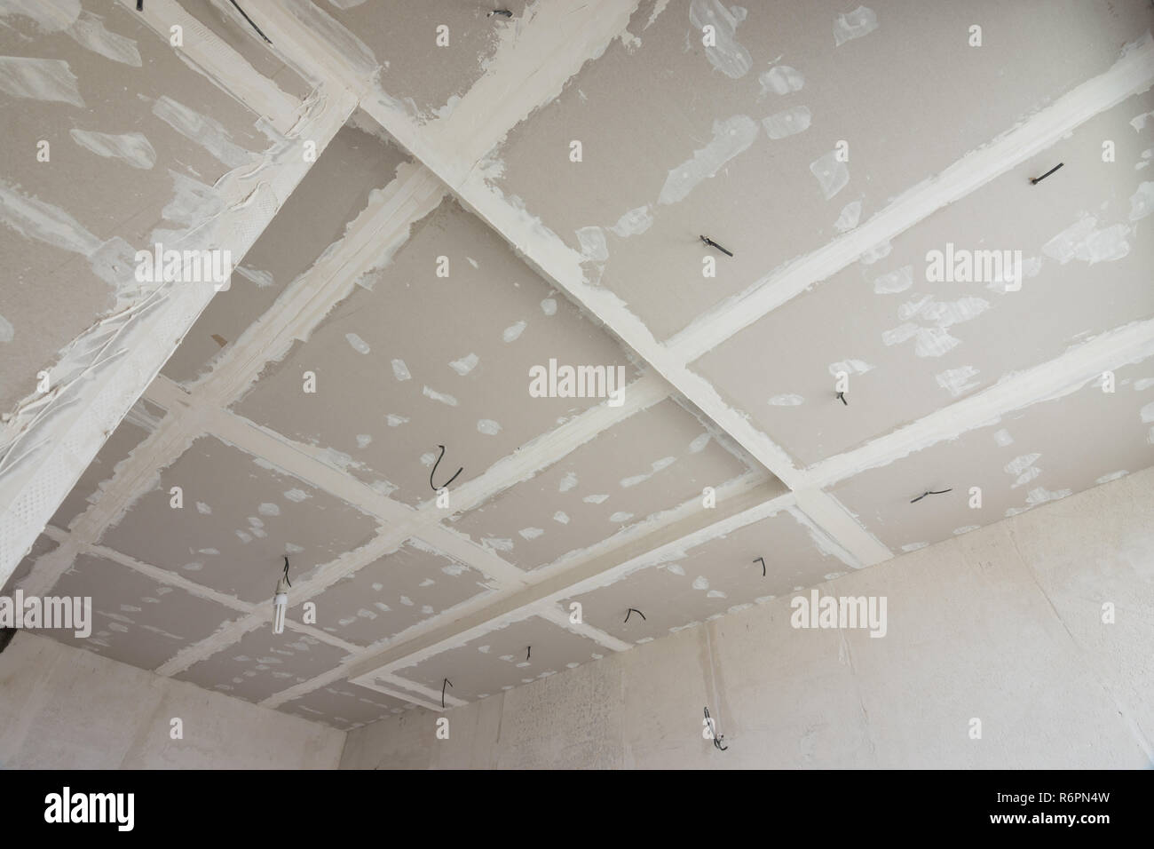 The Ceiling Of The Room Covered With Drywall Sheets The General