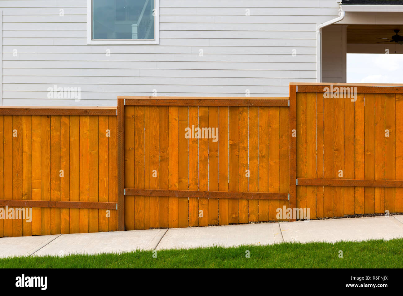 New Red Stained Garden Wood Fence Construction Stock Photo