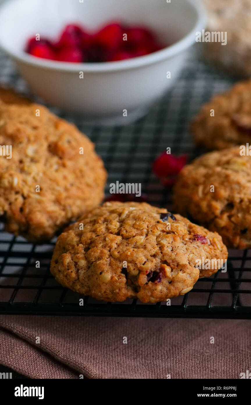 Homemade oatmeal cookies with dried fruits on a wire rack Stock Photo