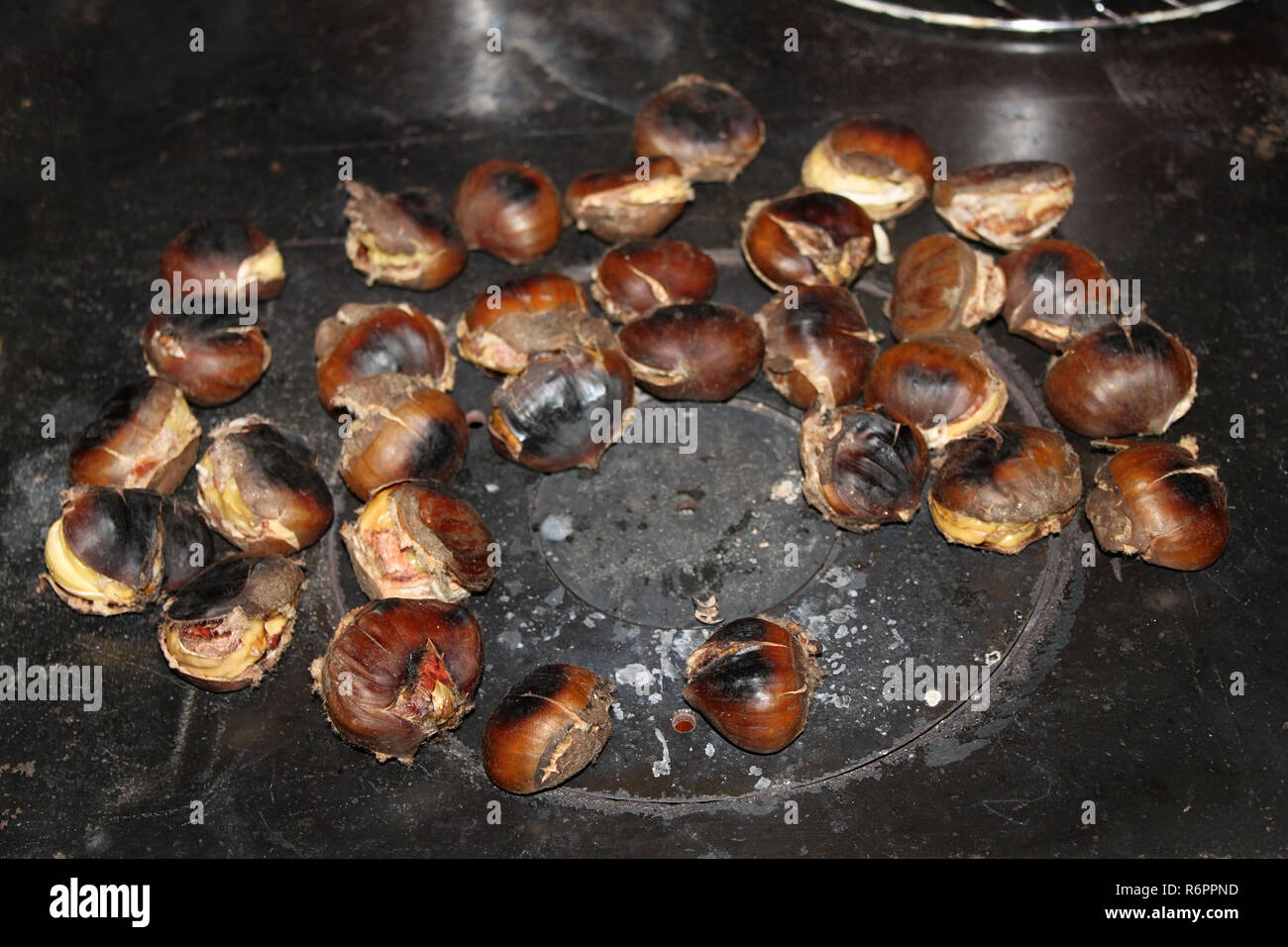 Chestnuts roasting on top of a traditional Lebanese stove called sobia