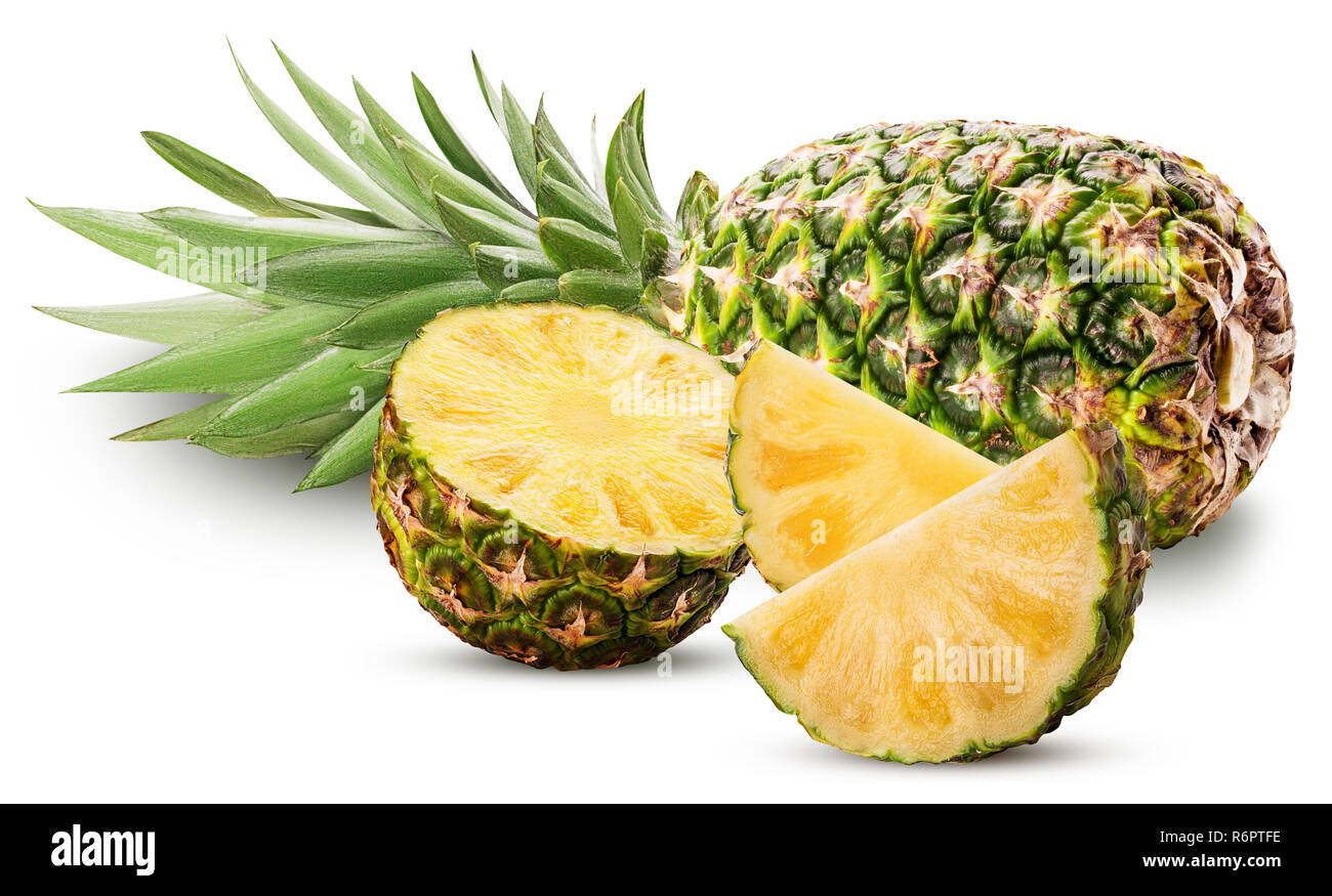 Pineapple fruit whole and cut in half and slice with green leaves ...