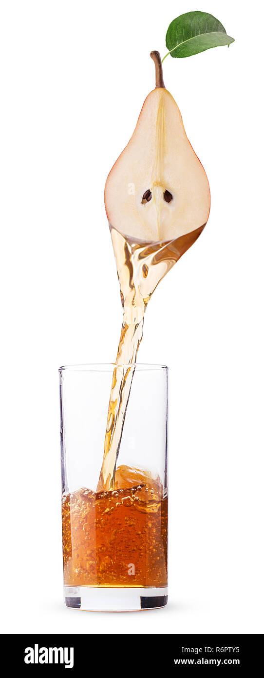 fresh pear juice pouring in a glass from half of pear fruit with leaf ...