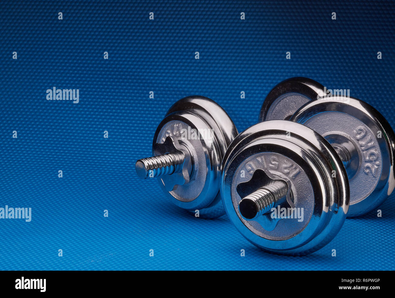 Steel dumbbell and weights Stock Photo Alamy