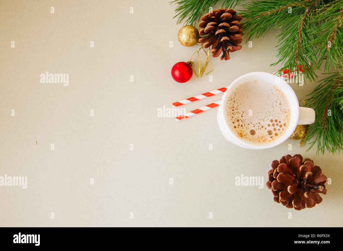 Christmas background with a cup of latte, fir tree branches, cones and ...