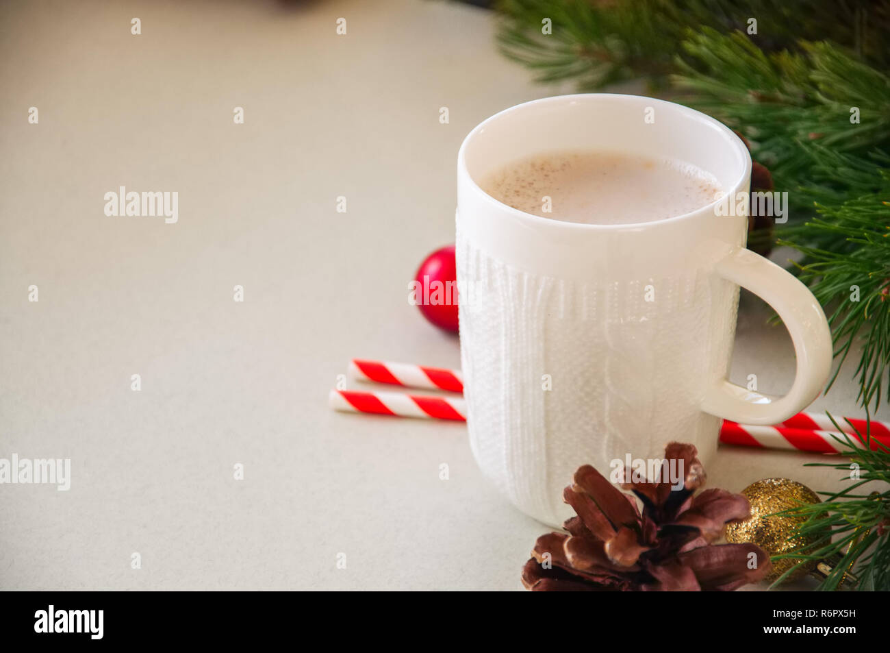 Christmas background with a cup of latte, fir tree branches, cones and ...