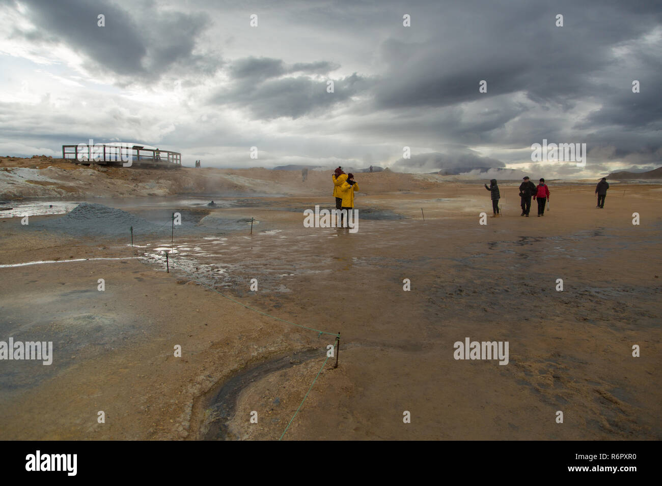 Tourists walk round looking at the geothermal area at Hverir, Namafjall, Iceland Stock Photo