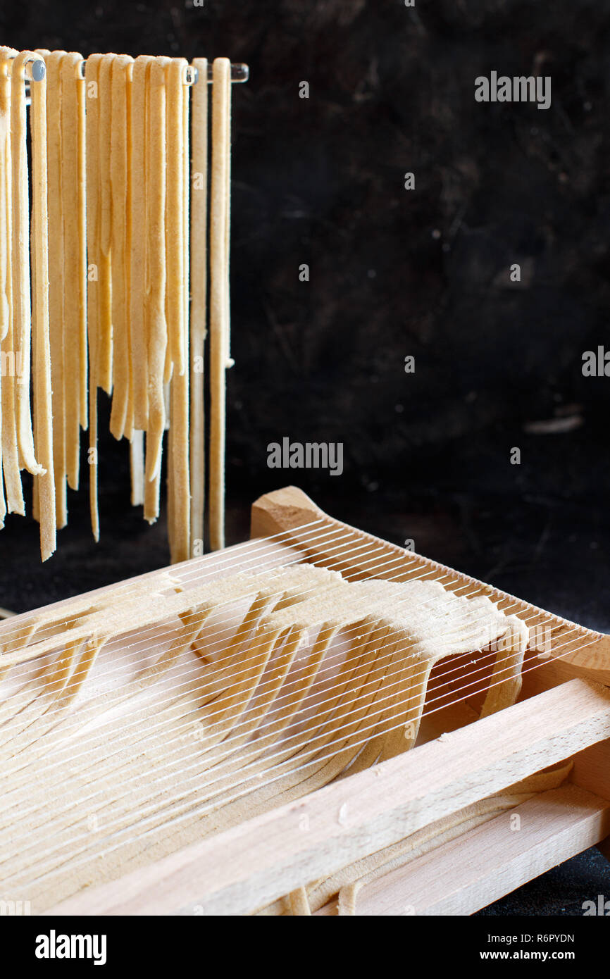 Making tagliolini pasta alla chitarra with a tool Stock Photo Alamy