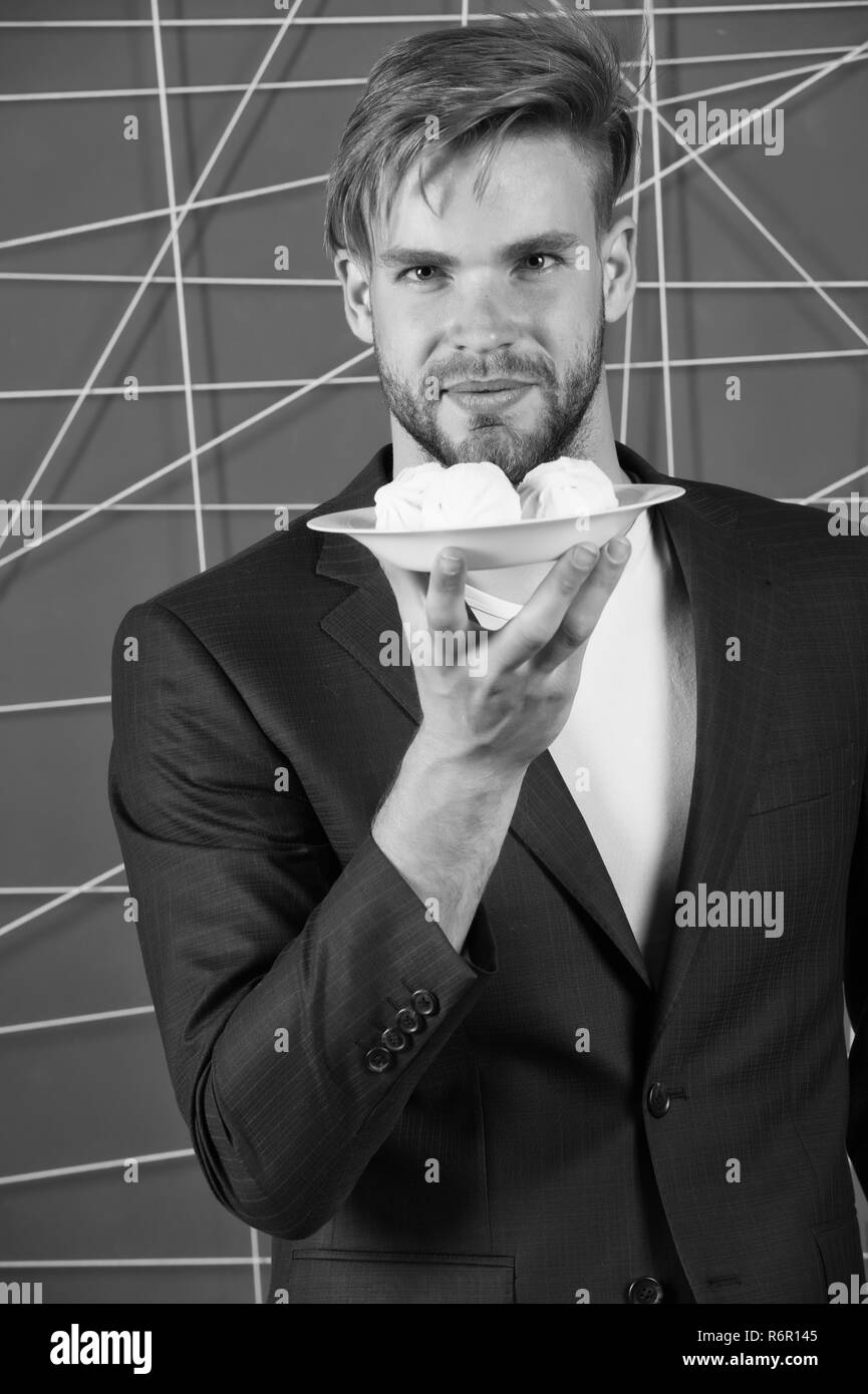 Man formal elegant suit hold plate with sweet marshmallow dessert