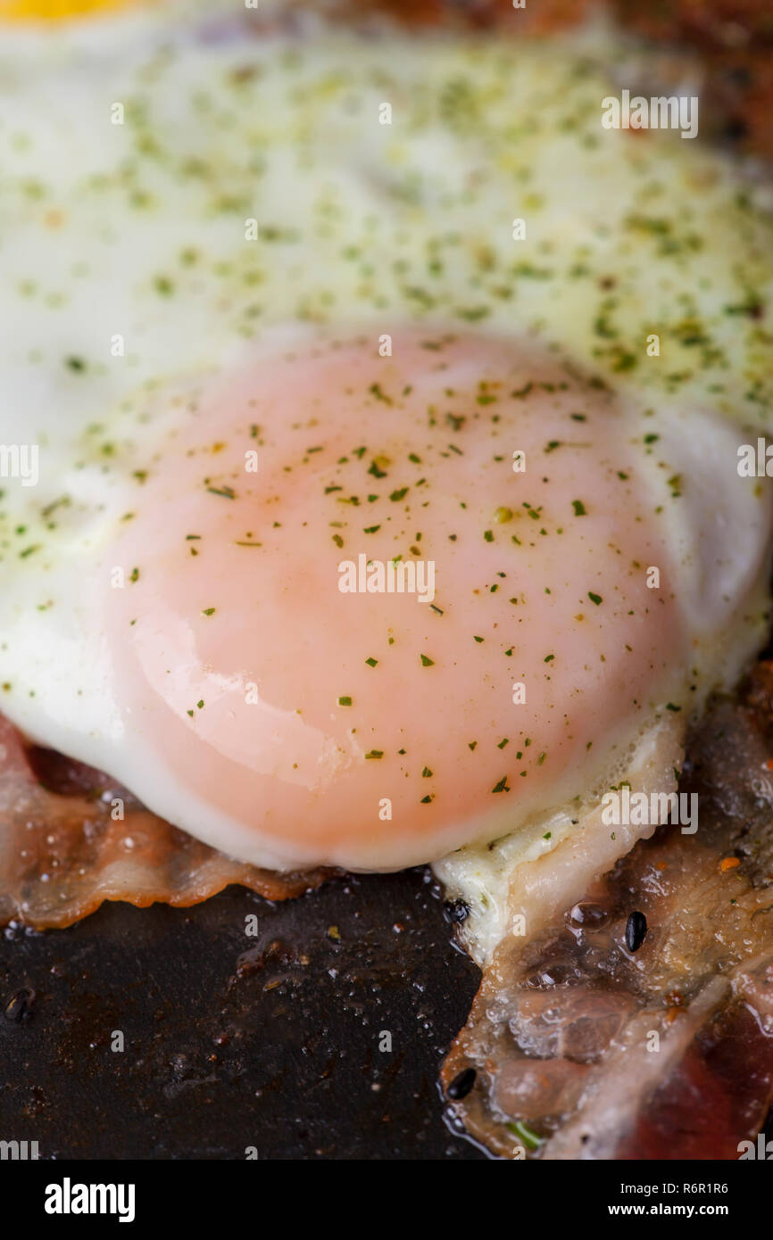 eggs with bacon in a pan Stock Photo