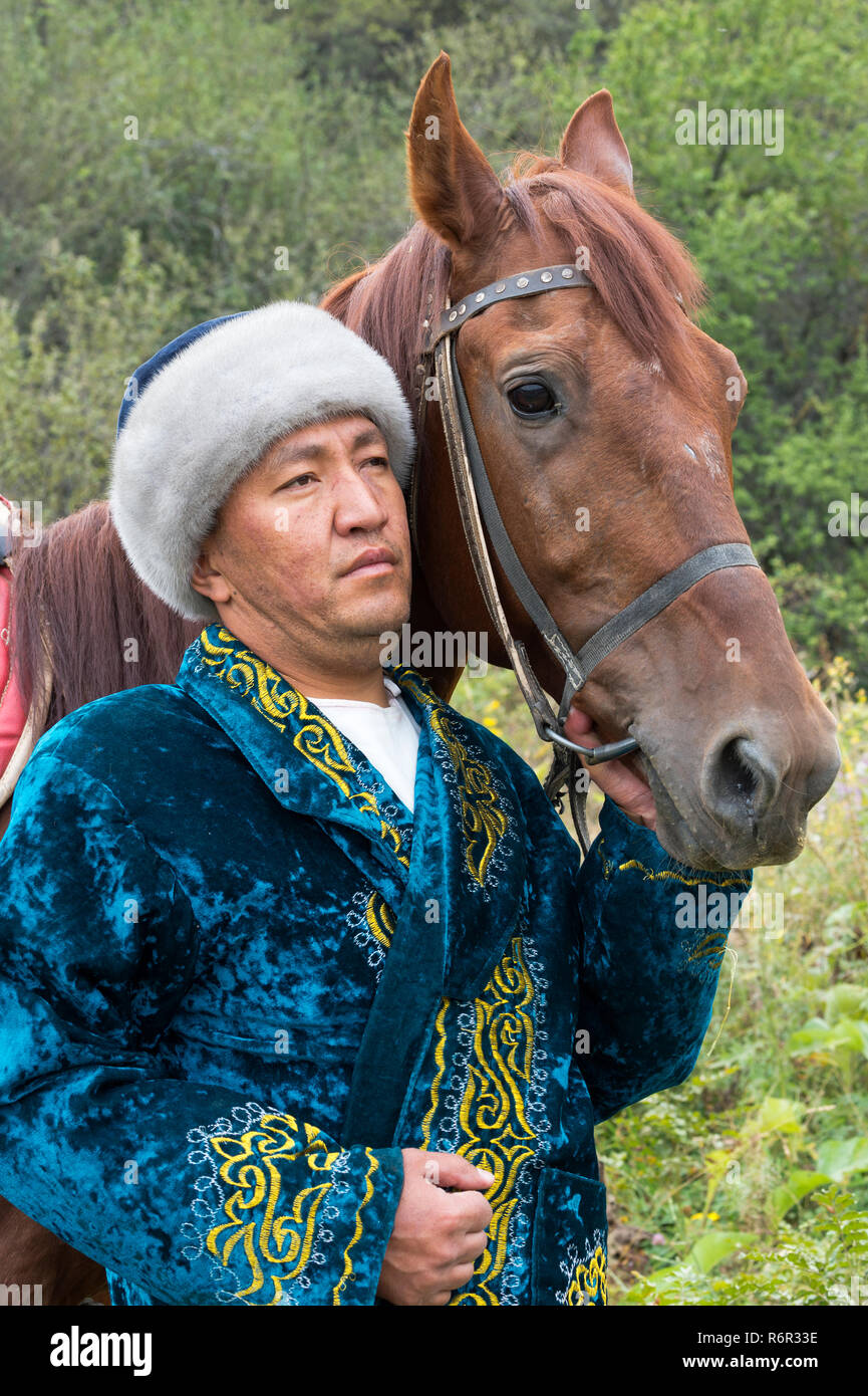 Kazakh man with his horse, Kazakh ethnographical village Aul Gunny, Talgar city, Almaty, Kazakhstan, Central Asia, For editorial Use only Stock Photo