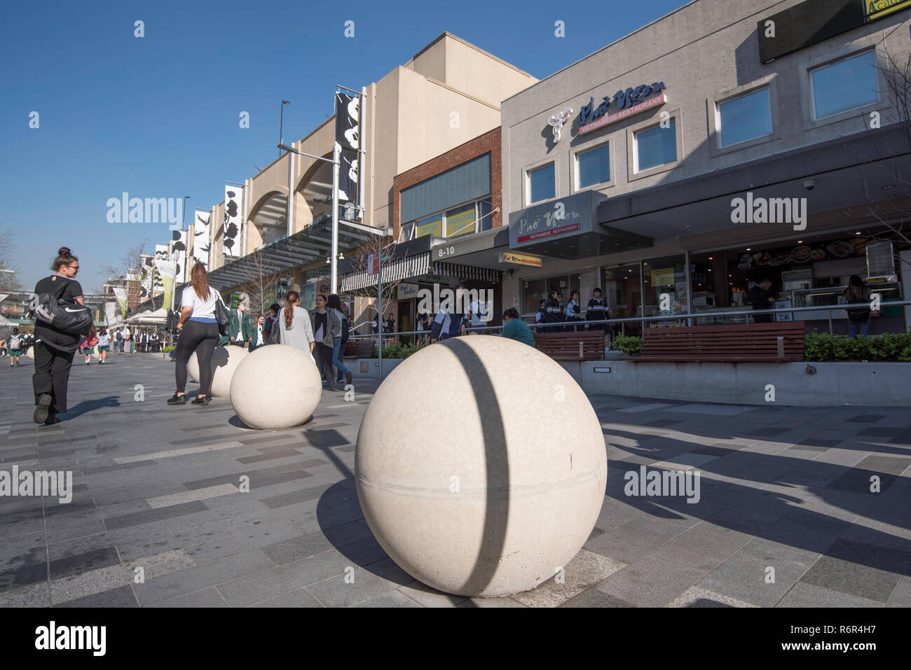 Security concrete bollards in Hornsby shopping area designed to prevent hostile and terrorist driven vehicles from invading pedestrian areas. Stock Photo