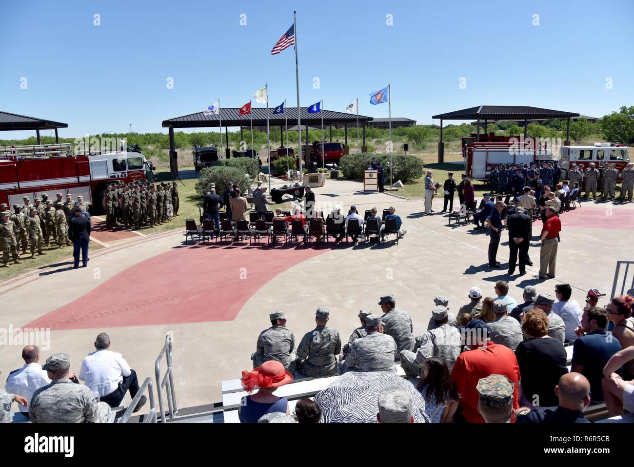 The 312th Training Squadron finalizes preparations for the memorial service at the Department of Defense Fallen Firefighter Memorial on Goodfellow Air Force Base, Texas, May 12, 2017. Each of the military services had a formation there to represent the joint training at the Louis F. Garland Department of Defense Fire Academy and to pay respect to the five fallen firefighters. Stock Photo