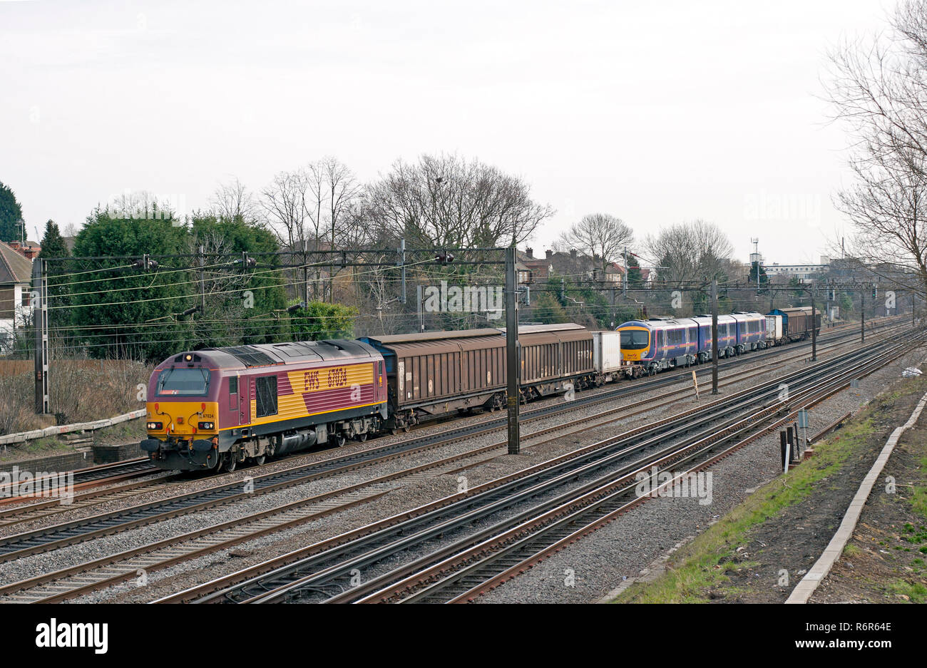 A class 67 diesel locomotive number 67024 hauling barrier wagons and a class 185 diesel multiple unit number 185110 at South Kenton. Stock Photo
