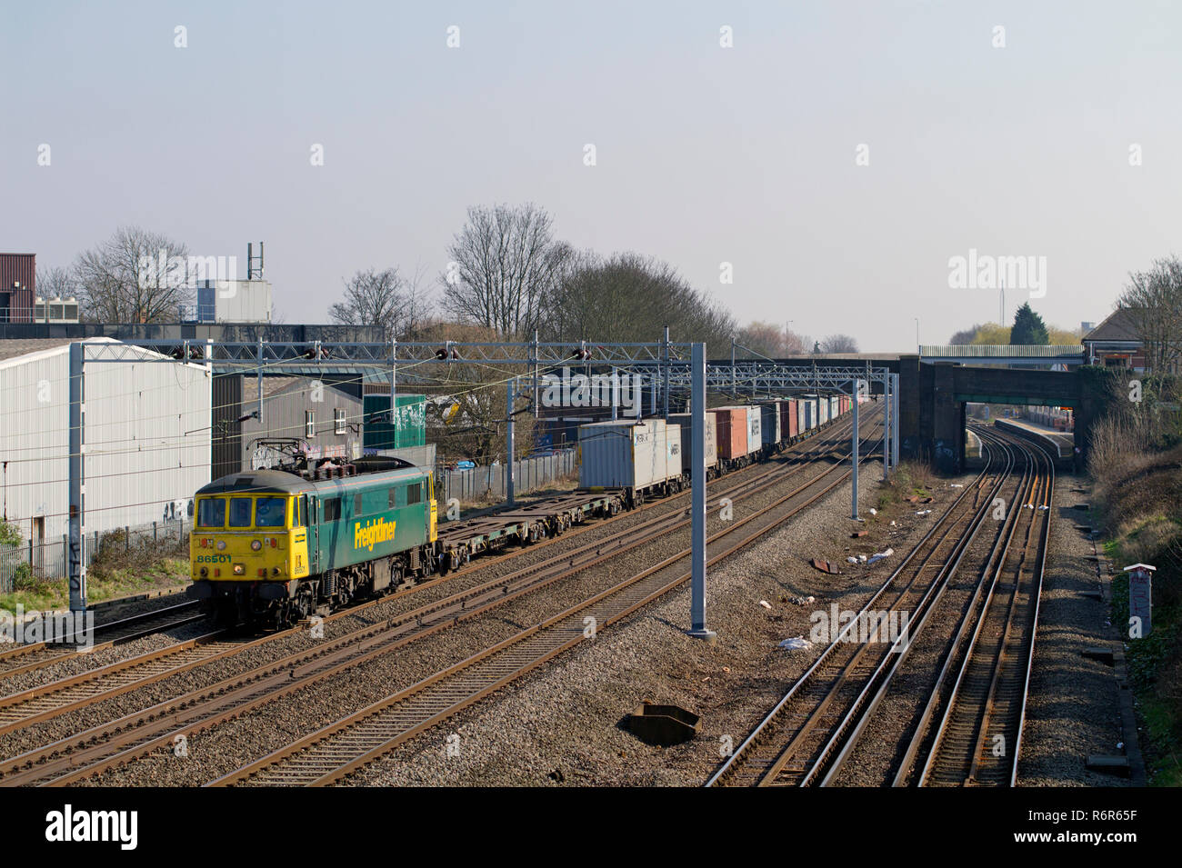 A class 86 electric locomotive number 86501 working a northbound Freightliner at Headstone Lane on the West Coast Mainline. Stock Photo