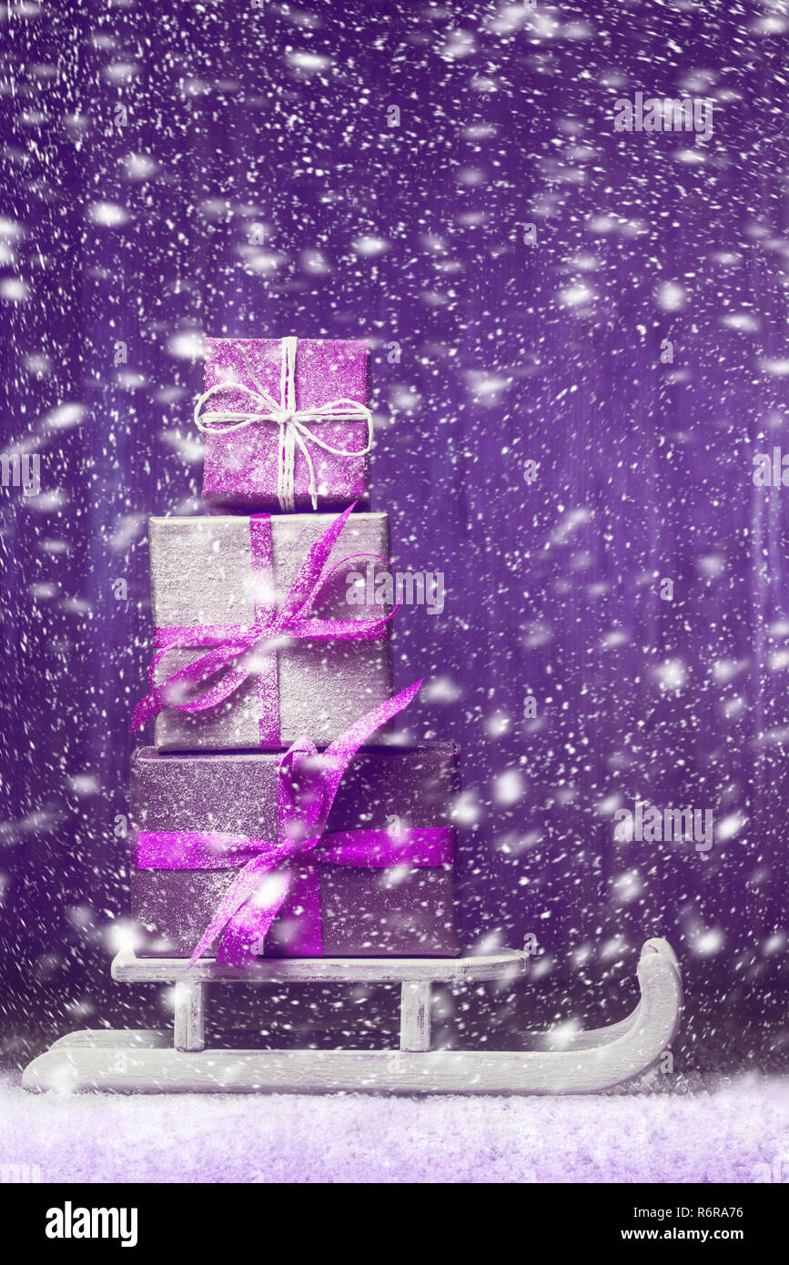 Pile of gift boxes on Santa's sledge with snowfall Stock Photo - Alamy