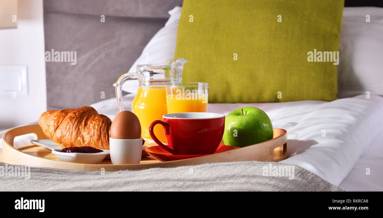 Breakfast on tray in bed in hotel room Stock Photo - Alamy