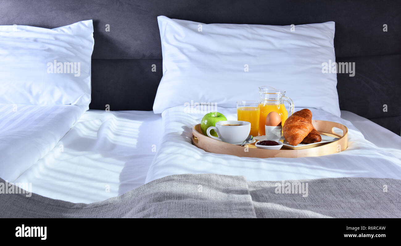 Breakfast on tray in bed in hotel room Stock Photo - Alamy