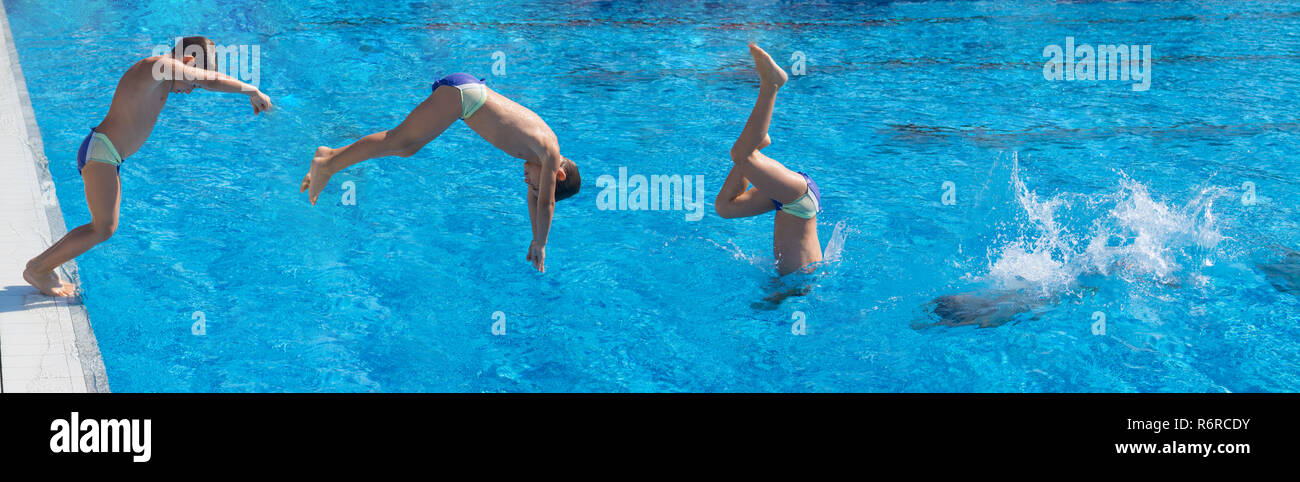 Seven year old boy doing swimming pool  dive with  splash Stock Photo