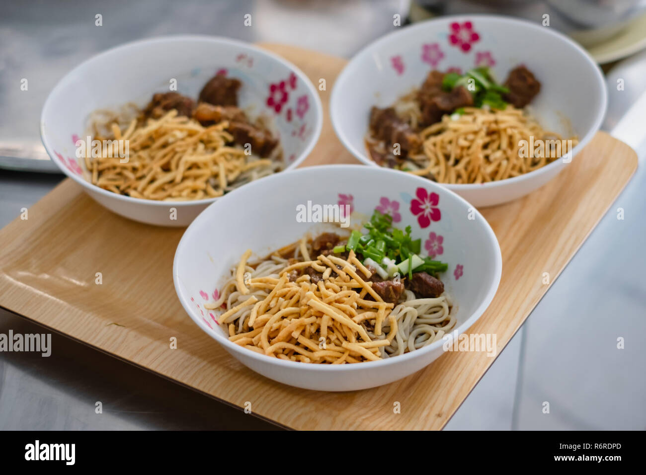 3 bowls of Khao Soi which Northern Thai Style Curried Noodle Soup with ...