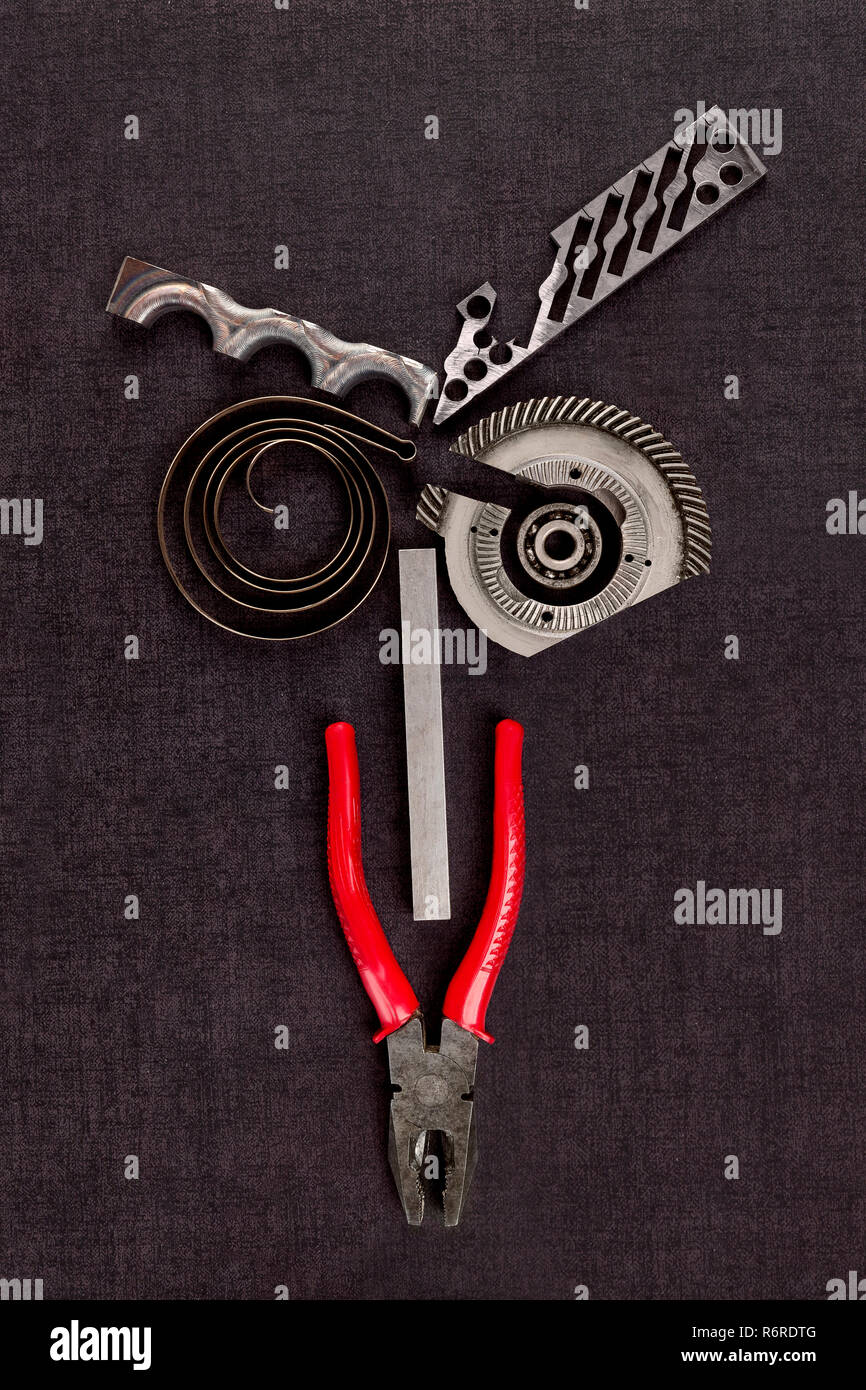 Screws, cogwheels and mechanical components on concrete. Stock Photo
