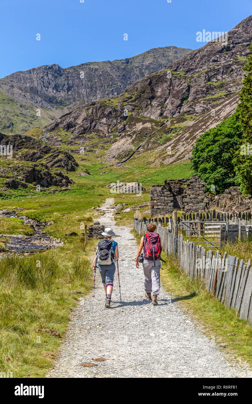 Two female hikers ascending the Watkin Path towards the summit of Snowdon, the highest mountain in the Snowdonia National Park in Wales. Stock Photo