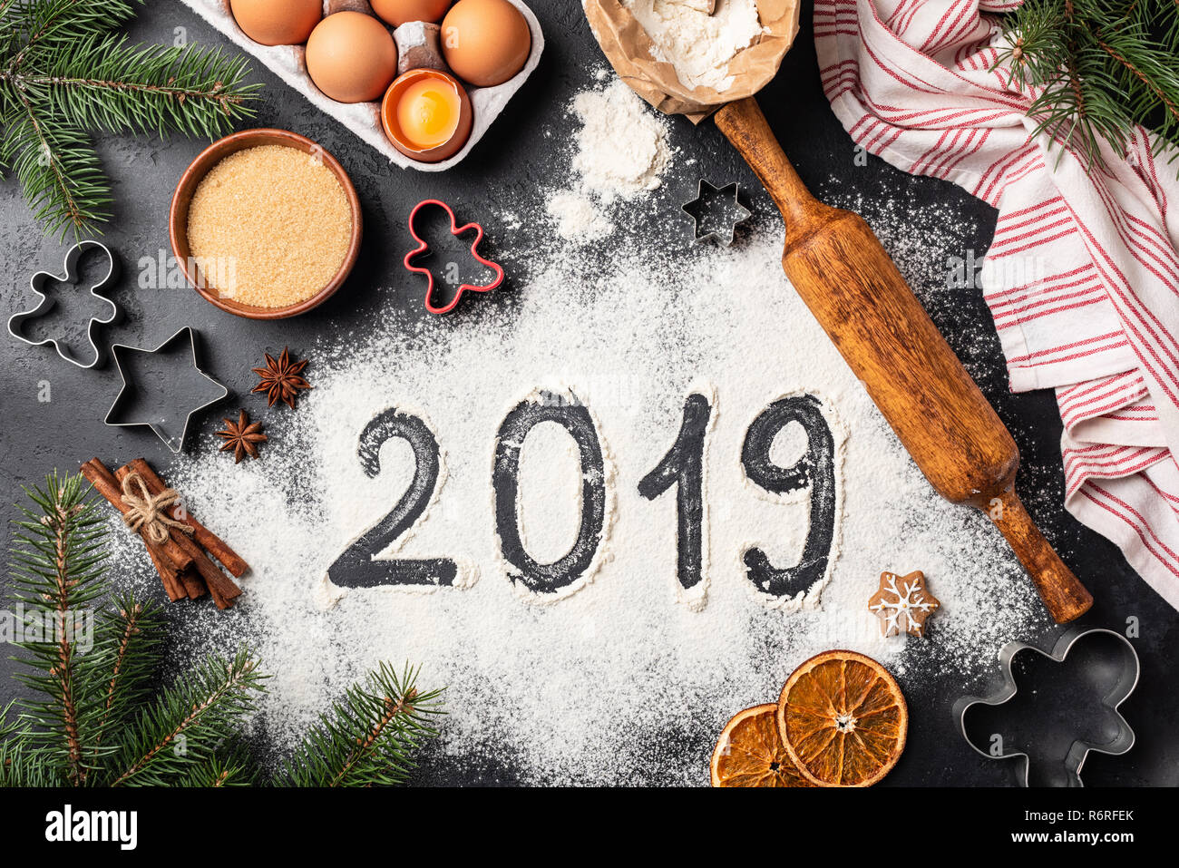 New Year 2019 written on flour. Baking Christmas gingerbread cookies. Top view Stock Photo