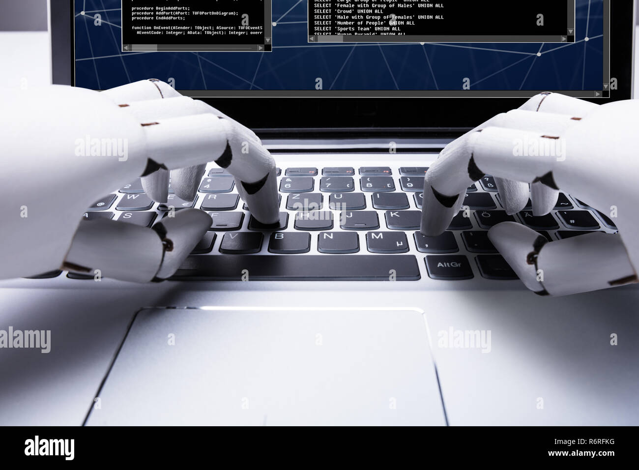 Robot Typing On Laptop Keypad Stock Photo