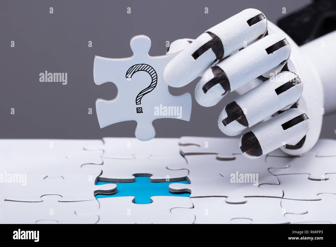 Robot Solving Jigsaw Puzzle Stock Photo