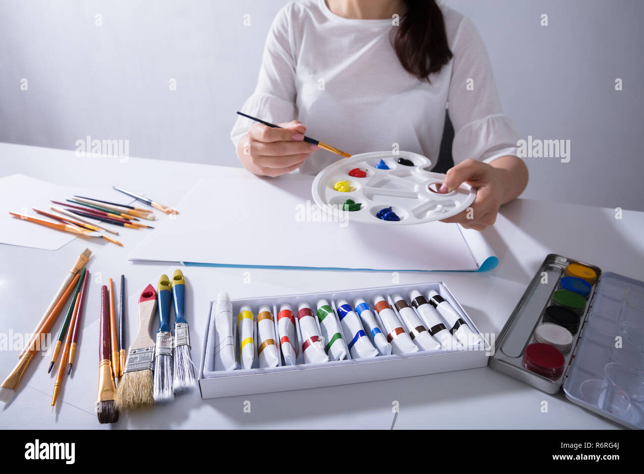 Female Artist Painting On Canvas Paper Stock Photo Alamy