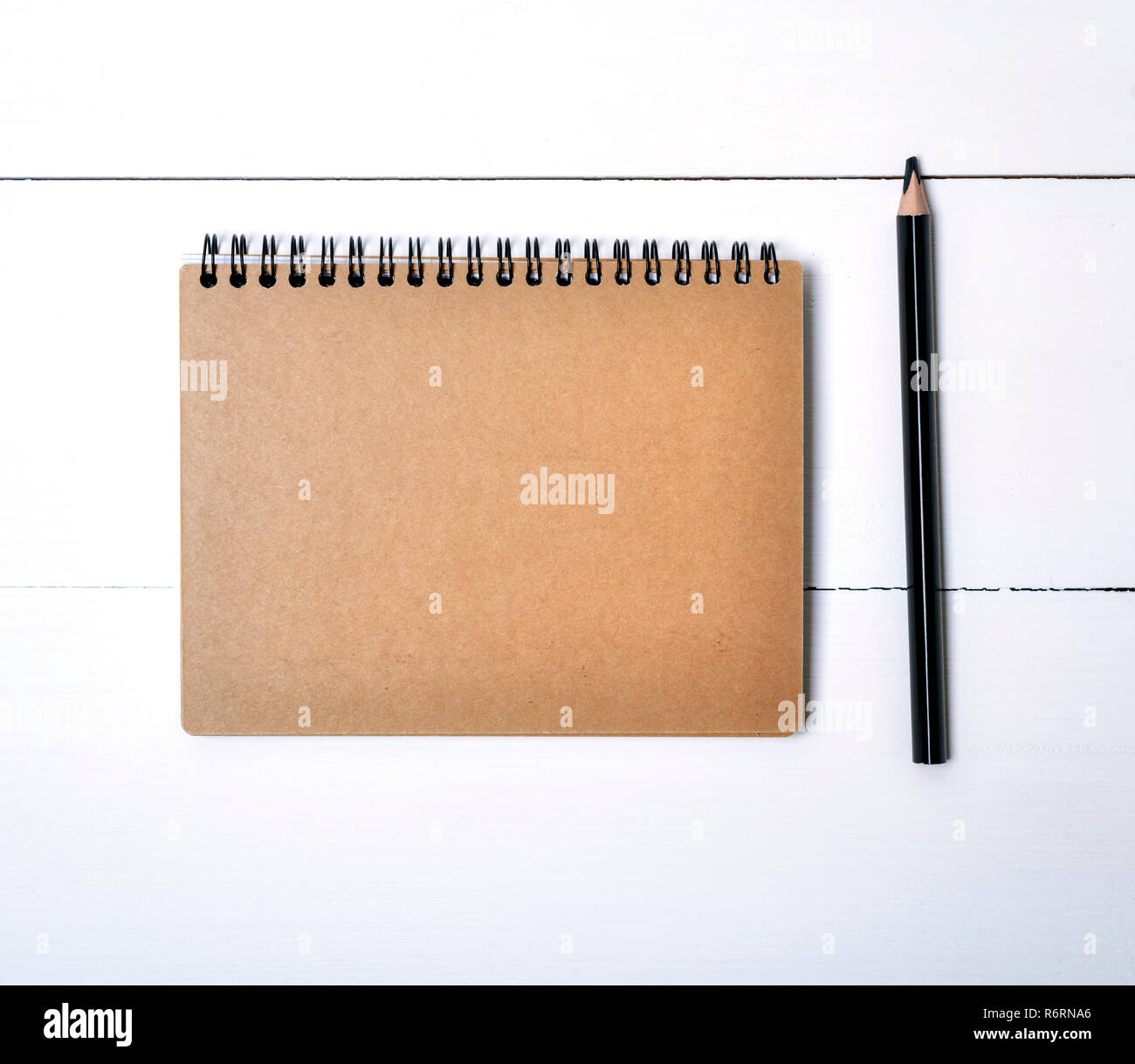 notebook on a black iron spring with brown empty sheets Stock Photo