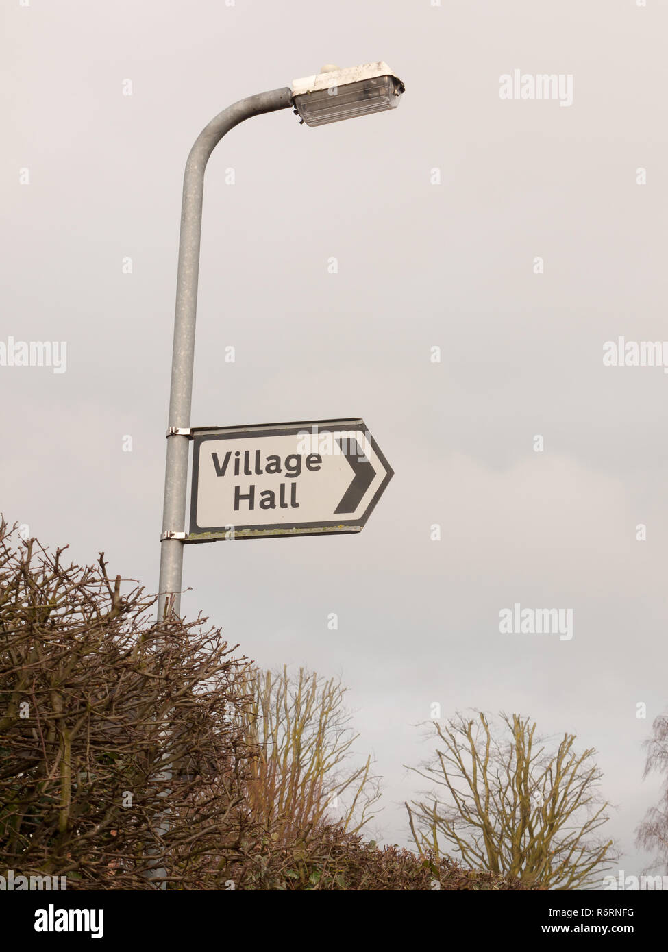 white and black village hall sign post direction street Stock Photo