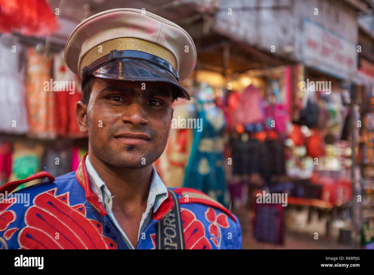 A uniformed member of a band of drummers in Mumbai, India, employed for religious celebrations and weddings Stock Photo