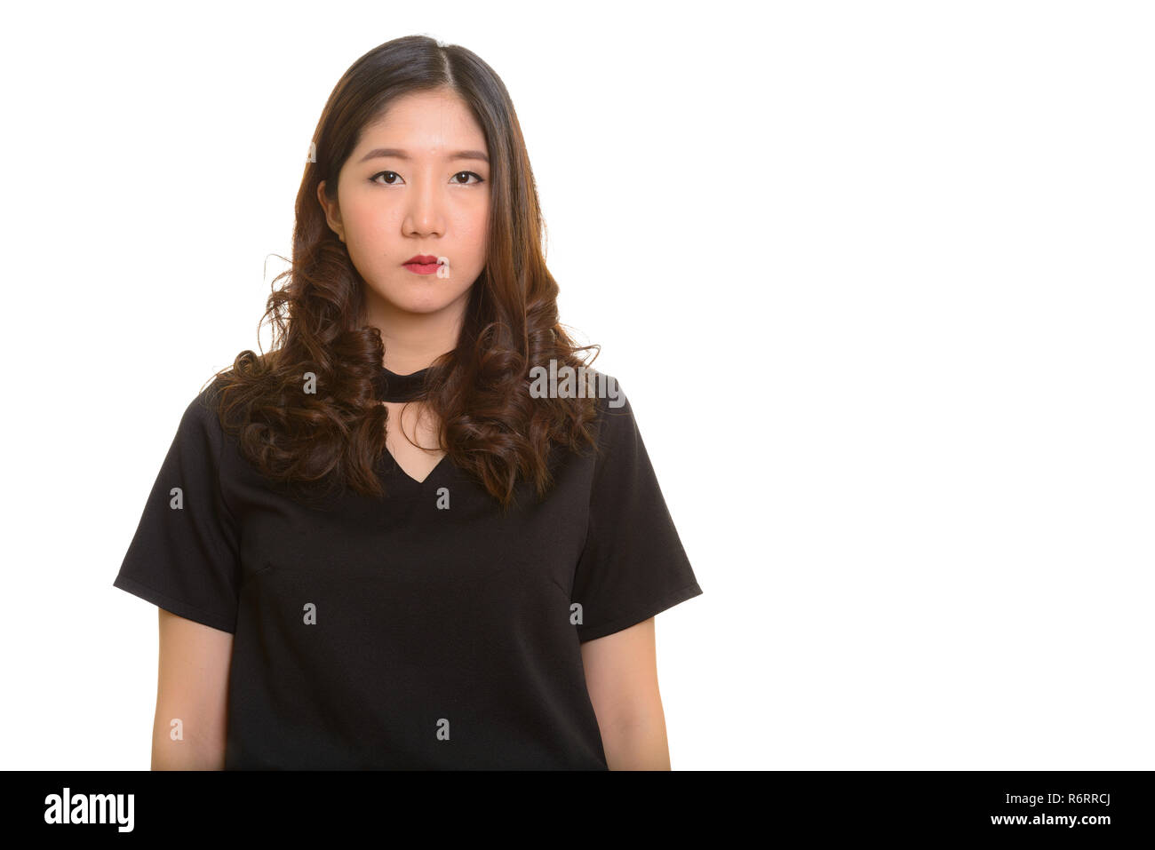 Portrait of young beautiful Asian businesswoman looking at camera Stock Photo