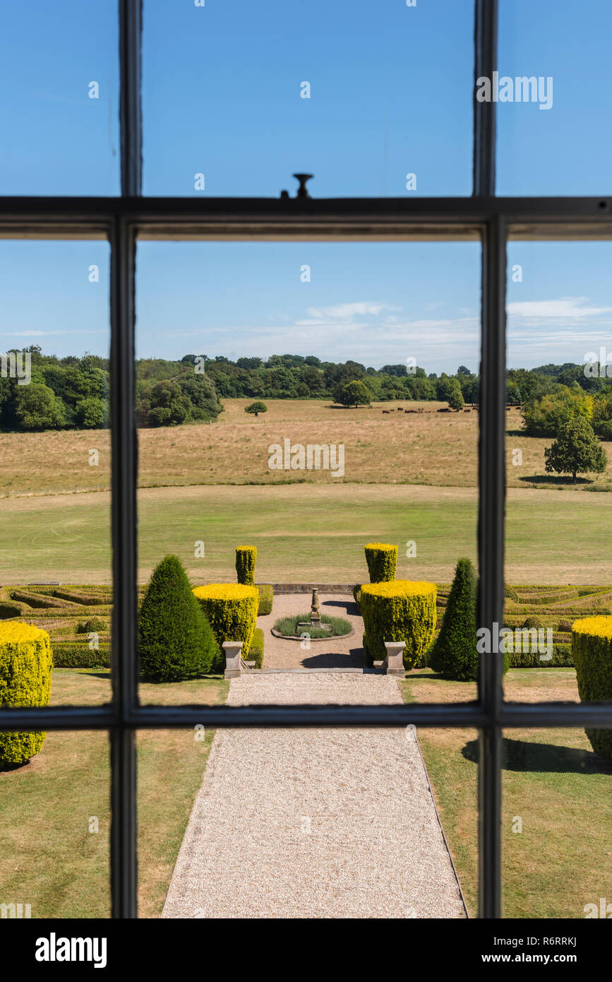 View through window to parterre garden of 18th century Goodnestone estate with view to Kent Stock Photo
