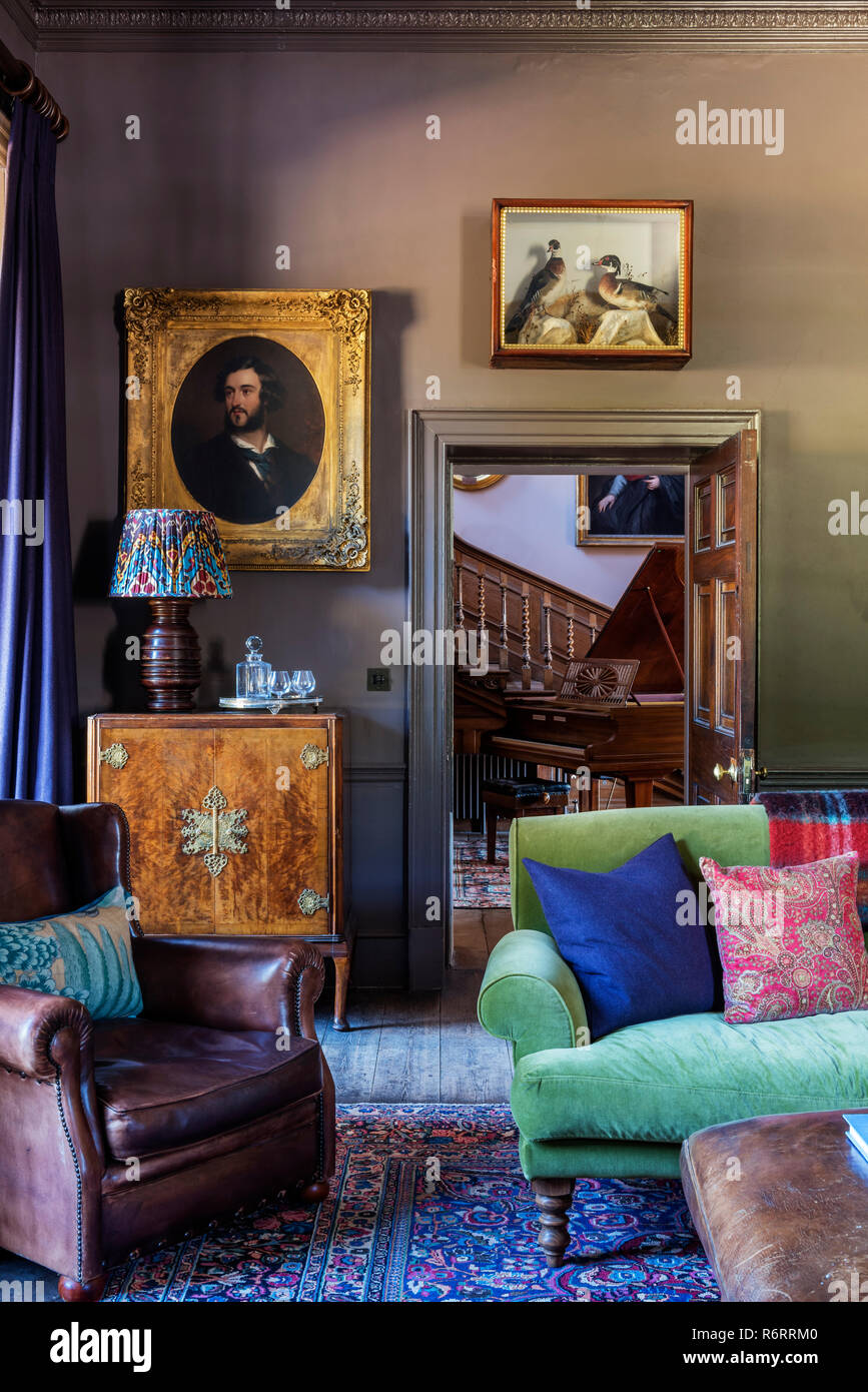 Leather armchair with antique wooden cabinet in library of 18th century Goodnestone mansion Stock Photo