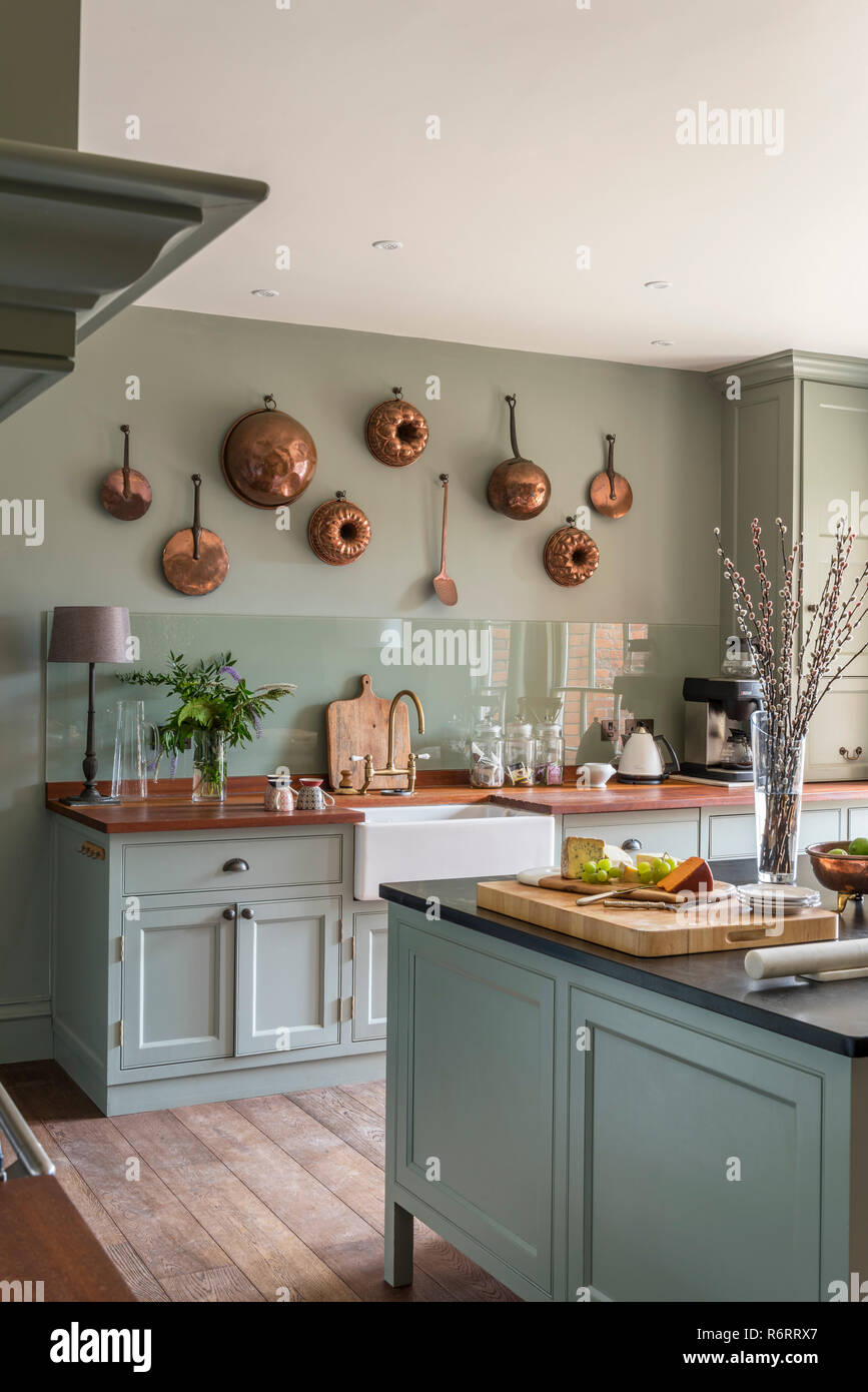 Copper jelly molds Light green modernised kitchen in 18th century Goodnestone Park mansion Stock Photo