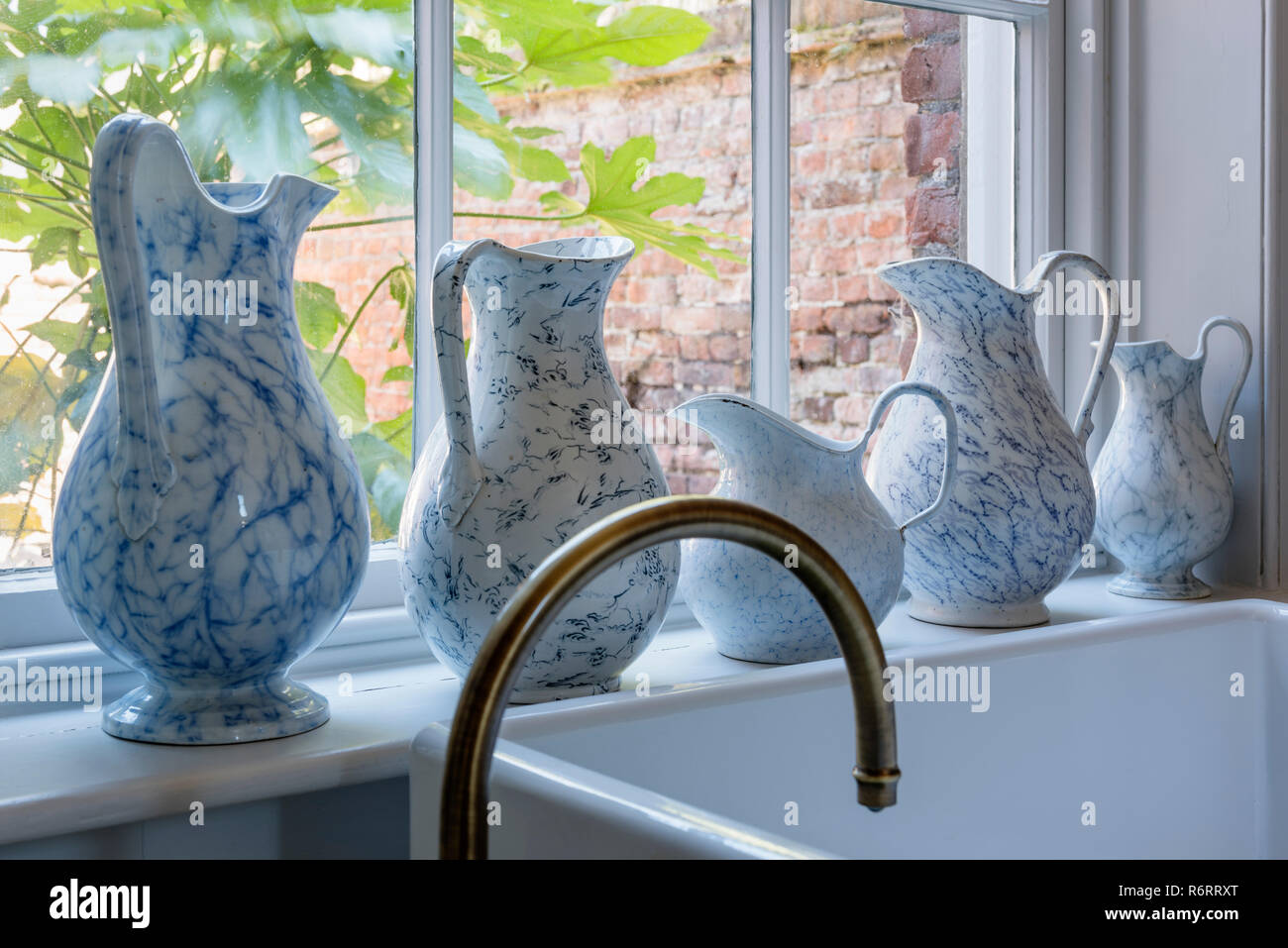 Ceramic jugs on windowsill in 18th century Goodnestone mansion Stock Photo