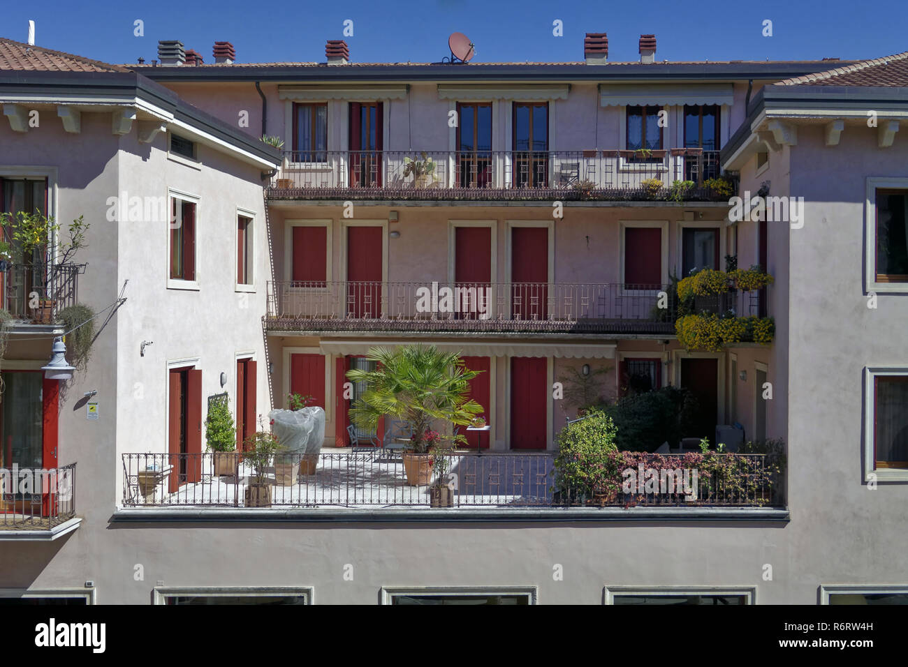 A terrace in Verona, Northern Italy with potted plants, palm trees and flowers Stock Photo