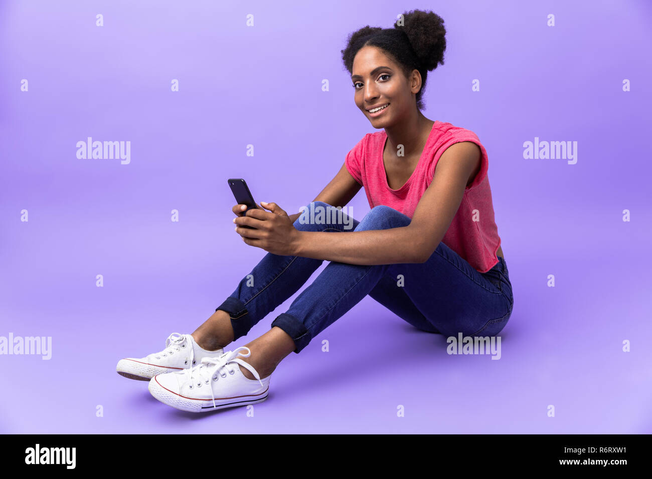 Photo of attractive african american woman smiling and holding ...