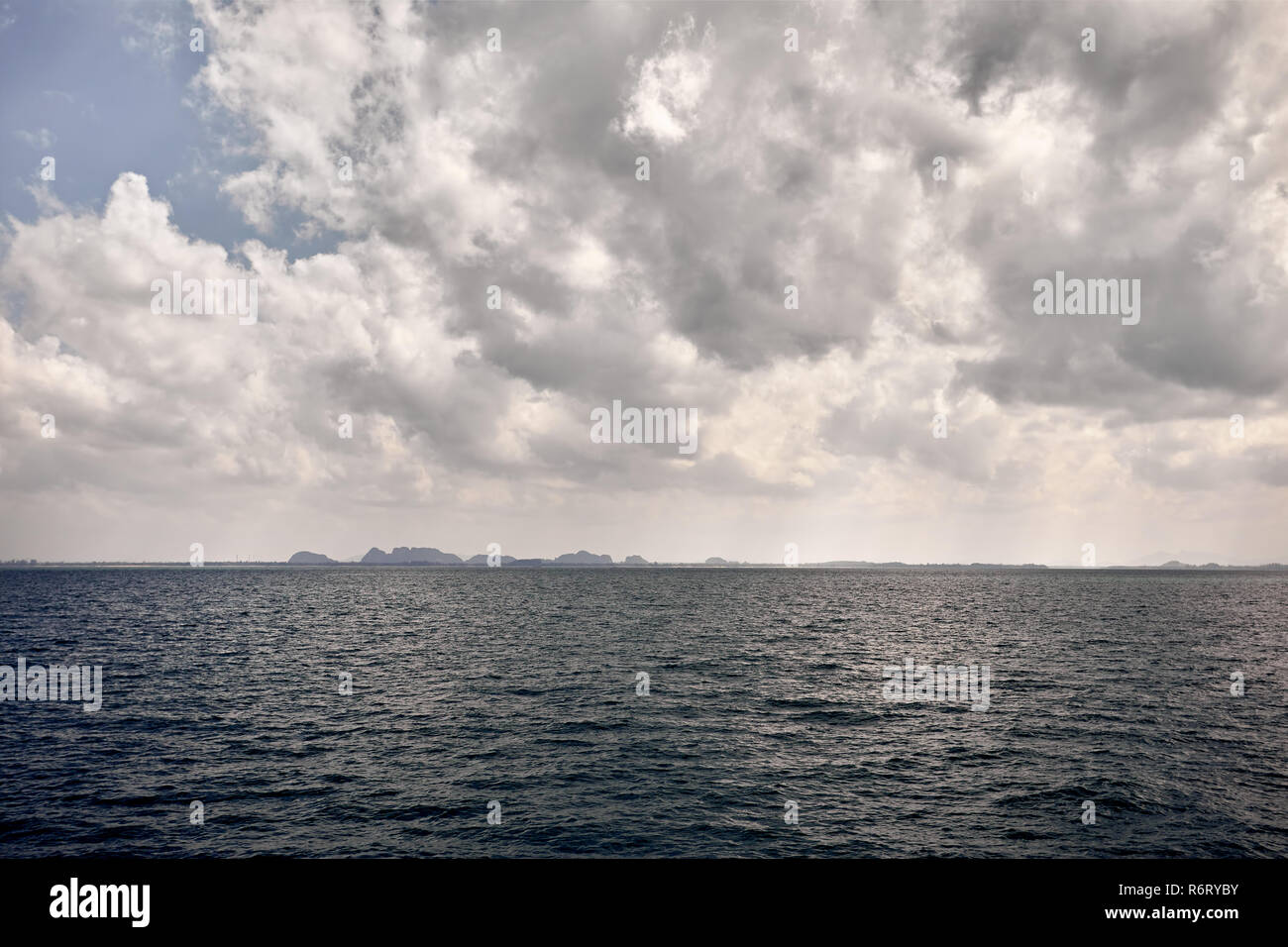 Tropical islands Phang Nga in Andaman sea of Krabi province at overcast cloudy sky in Thailand Stock Photo