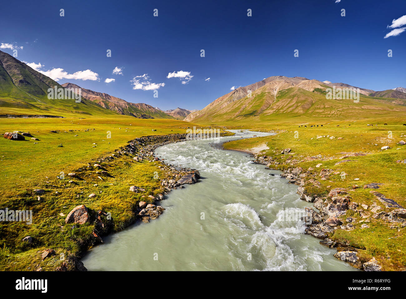 Mountain river in the mountain valley at blue sky in Kyrgyzstan Stock Photo