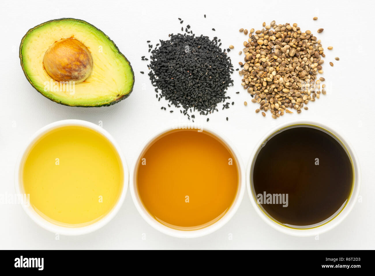 health oils from avocado, black seed and hemp seeds top view of
