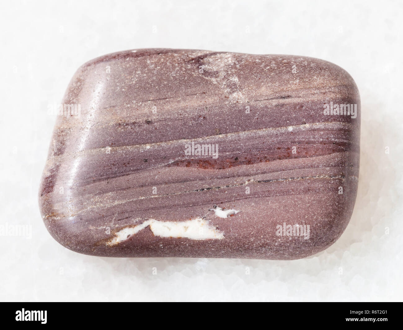 tumbled Argillite gemstone on white marble Stock Photo