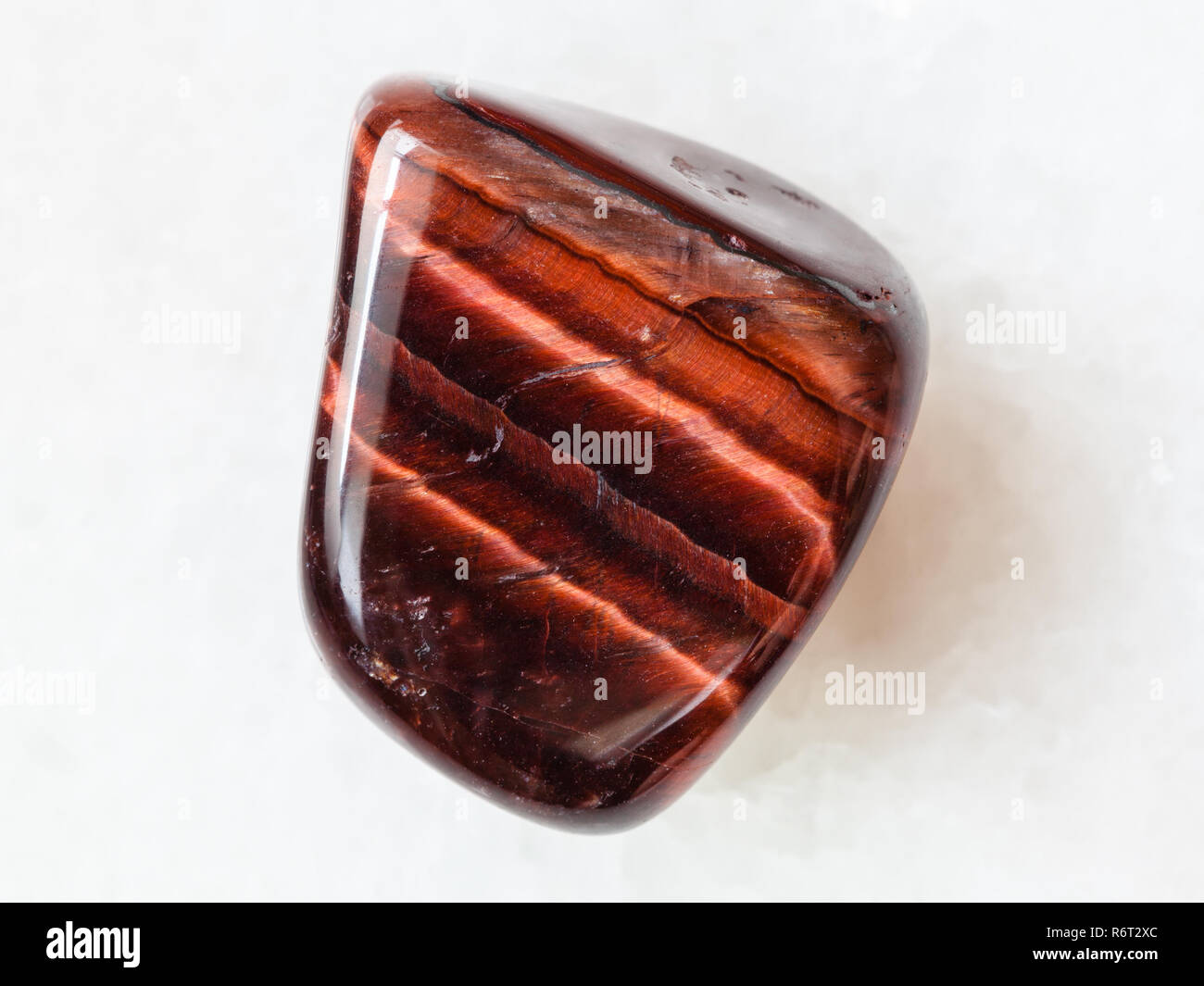 tumbled Bull’s Eye gemstone on white Stock Photo - Alamy