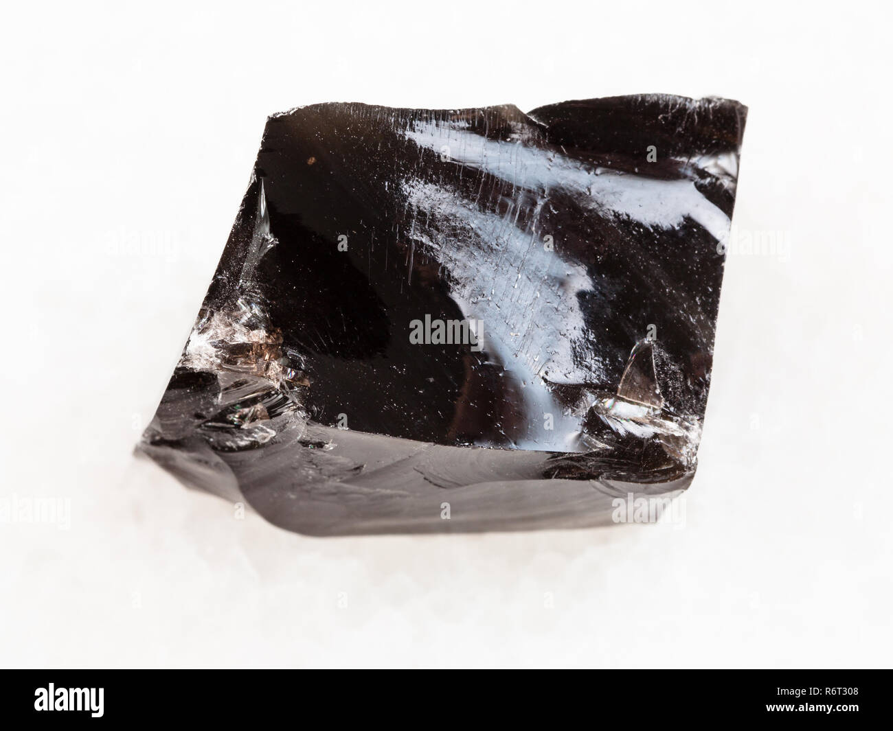 piece of rough Obsidian stone on white Stock Photo - Alamy